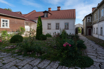 View of the courtyard of a traditional merchant's estate on the main street of Izborsk Pechorskaya...