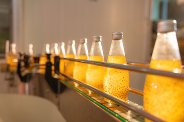 Juice in glass bottles in a factory for the food industry, bottling and transport, Drink factory...