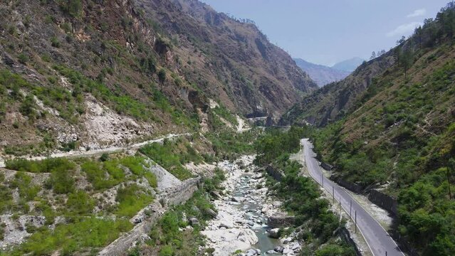 Drone Shot of a small road and river in Himachal Pradesh near Manali, Kasol