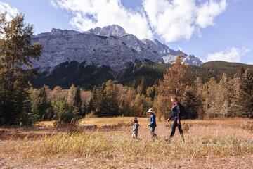 Fototapeta na wymiar Mother and children walking in the mountains in Autumn