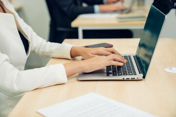 closeup hands of businesswoman working at office, woman typing keyboard on laptop or computer.