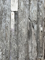Old wood planks texture background due to exposure to weather, vertical view.