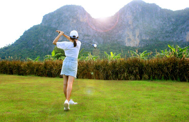 Actions of Asian girls golfer starting the tournament from long distance golf on the golf course...