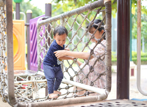 Asian Toddler Boy enjoy playing in Playground