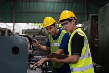 Group of Asian male engineer working in the industry factory. Team male technician maintaining machines in the factory