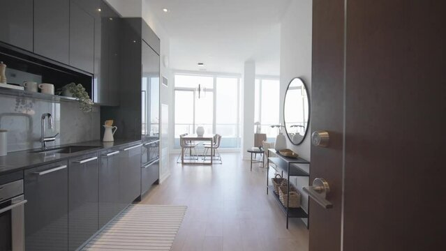 Door opening intro enter into a cozy high-rise residential penthouse unit in a condominium during a sunny day