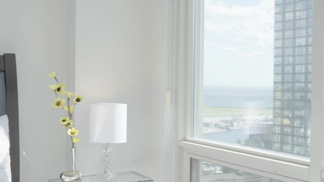 Reveal the view from the bedroom of a high-rise condominium unit