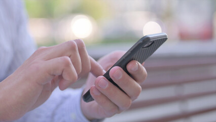 Close Up of Male Hand Using Smartphone Outdoor