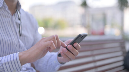 Close Up of Young Adult Man Using Smartphone Outdoor