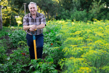 mature man farmer posing in estate garden