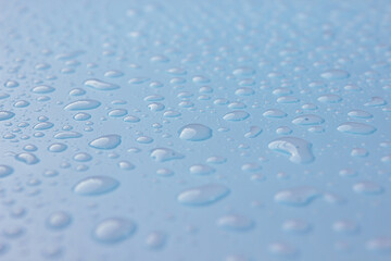Close up of dropped water on blue background. Freshness, raindrop