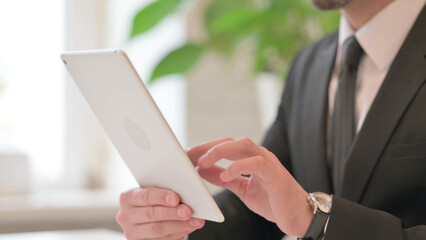 Close up of Hands of Middle Aged Businessman working on Tablet