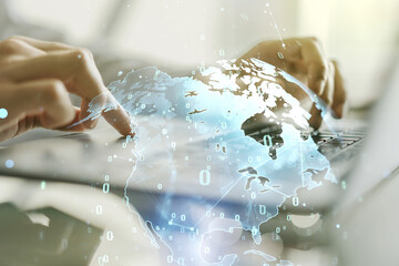 Abstract creative coding concept with world map and hands typing on laptop on background. Multiexposure