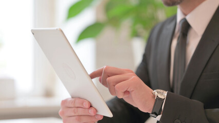 Close up of Hands of Middle Aged Businessman Celebrating Success on Tablet