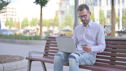 Young Adult Man making Successful Online Payment on Laptop