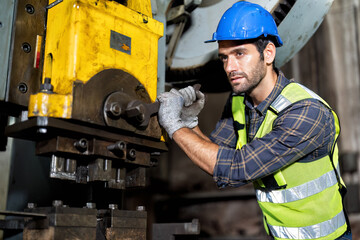 maintenance engineer hold the wrench tighten bolt at hydraulic compression machine portrait smiling...