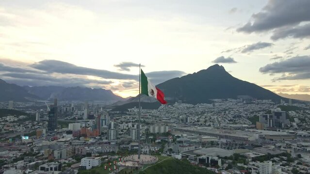 Mexico flag waving on Cerro del Obispado, Monterrey aerial view 360
