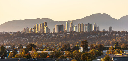 View of Burnaby, Greater Vancouver area on a sunset with mountains at the background. - obrazy, fototapety, plakaty