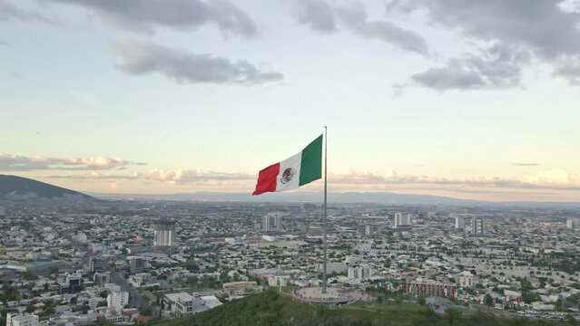 Mexico flag waving on Cerro del Obispado, Monterrey aerial view