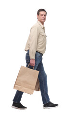 Side view of going man thoughtfully carries shopping bags.