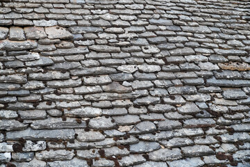 tiled grey ancient medieval roof background with old vintage gray tiles roofing