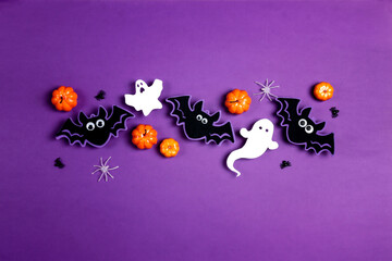 Halloween composition with cute bats, ghosts, pumpkins, spiders on purple background. Happy halloween banner mockup.