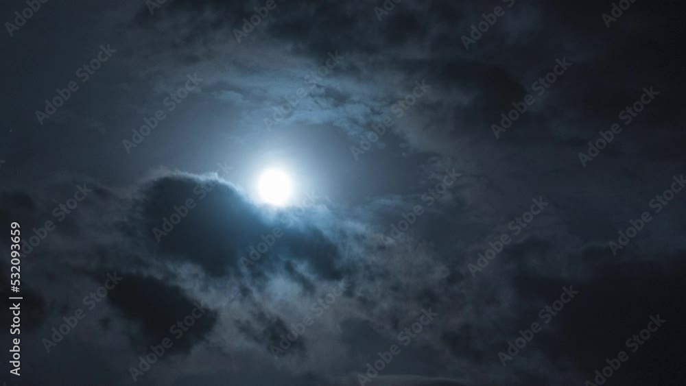 Sticker full moon with moving clouds. night timelapse with clouds floating by. smooth departure of the camer