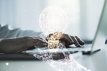 Creative idea concept with light bulb illustration and hands typing on laptop on background....