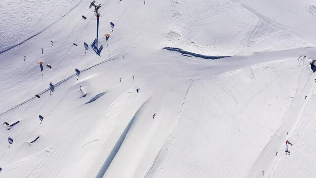Montana, Switzerland: Top down aerial footage of the famous Crans-Montana ski resort slope with the  Cry d'Er cable car and ski lifts station in Valais in the Swiss alps in winter. 