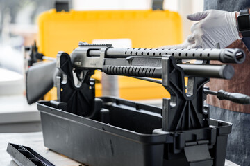 Automatic rifle on stand on the table of the weapons workshop