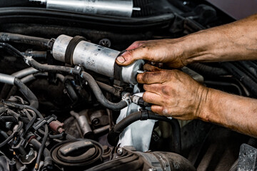 Fototapeta na wymiar Close up of auto mechanic repairing car engine in car service