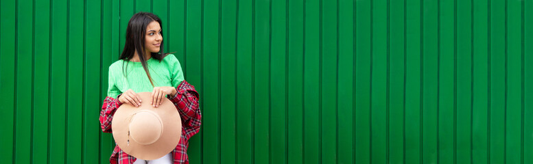 young urban hipster girl posing at the wall