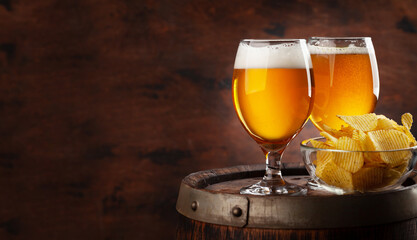 Beer glasses on wooden barrel
