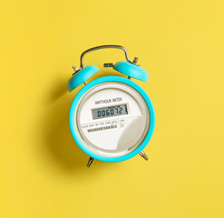 Electric meter with alarm clock on a yellow background