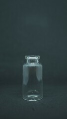 Empty glass bottle on dark background