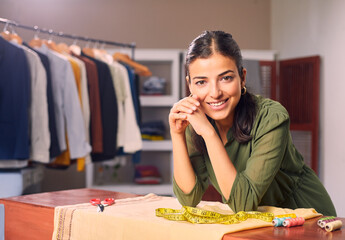 A Modern Happy smiling Young attractive Indian Asian woman or female professional fashion stylist...