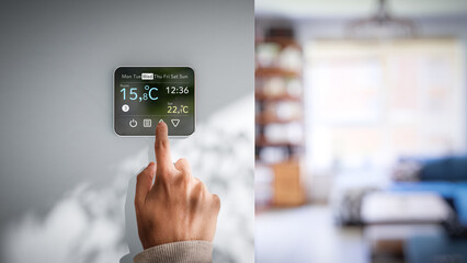 Setting room temperature on wall thermostat - Low winter temperatures in homes caused by the energy crisis in Europe - obrazy, fototapety, plakaty