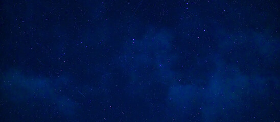 Starry Milky Way at night with stars on the background of a dark blue night sky - obrazy, fototapety, plakaty