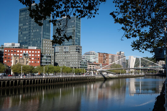 The Zubizuri footbridge or white bridge in Blibao on a sunny day. The bridge is functional but its stylish design makes it a popular photo opportunity for tourists 