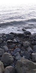 Fototapeta na wymiar rocks next to the water on the beach of the sea