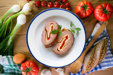 Roll of minced meat stuffed with red pepper, ham and cheese. Traditional Spanish recipe.