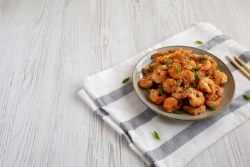 Homemade Crispy Salt and Pepper Shrimp with Scallions on a Plate, side view. Space for text.