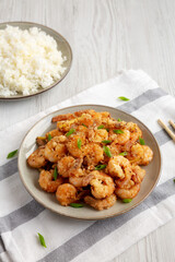 Homemade Crispy Salt and Pepper Shrimp with Scallions on a Plate, side view.