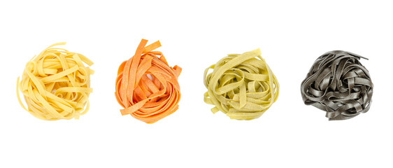 Tagliatelle pasta in different colors, twisted into nests, from above, isolated, over white....