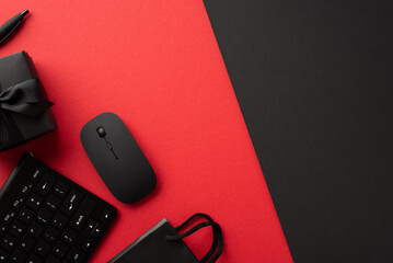 Cyber monday concept. Top view photo of keyboard computer mouse black giftbox with ribbon bow pen and paper bag on bicolor red and black background with empty space