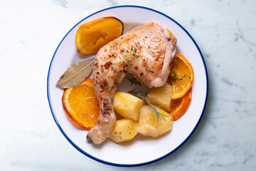 Baked chicken cooked with orange and potatoes. Traditional Spanish recipe.
