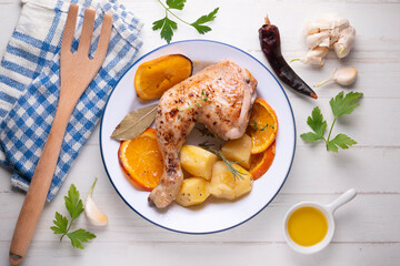 Baked chicken cooked with orange and potatoes. Traditional Spanish recipe.