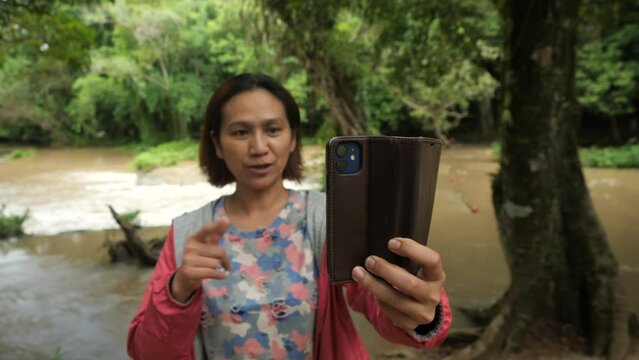 Asia women traveling in the rain forest 