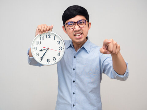 Asian manager man show analog clock point finger at you isolated
