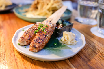 Grilled pork stick with while sesame on the plate.